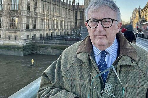 Jamie Stone MP stood on Westminster Bridge